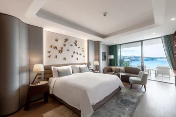 Fotobehang Hotel chique Modern hotel room with a bright and airy feel, a luxury hotel room. Example of a hotel room, modern furnishings and architecture.  © ismailbasdas