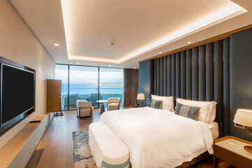 Modern hotel room with a bright and airy feel, a luxury hotel room. Example of a hotel room, modern furnishings and architecture.
