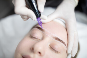 In a stylish salon, a woman relaxes as a technician expertly applies permanent makeup to her...