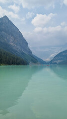 The iconic Lake Louise in summer located in Alberta, Canada with blue sky background overlooking the stunning turquoise lake.