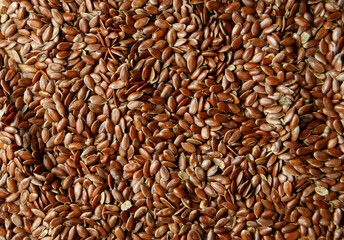 A close-up photo of flax seeds, highlighting their rich texture and natural shine. 