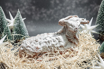 Christmas lamb cake with traditional New Year decor. Baked sweet dessert with sugar icing