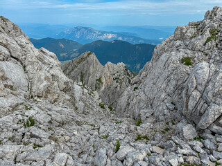 Hiking trail with scenic view of rugged mountain peak Dobratsch in Julian Alps seen from Triglav...