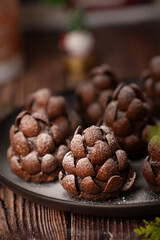 Christmas food dessert in the shape of brown pinecone on the plate  