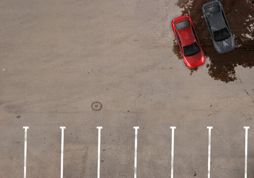 Cars Seeking Shade in an Empty Parking Lot