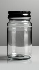 A clear glass jar with a black lid, suitable for storage or preservation.