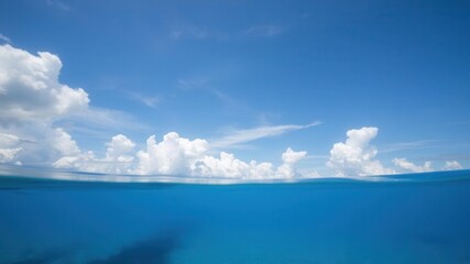 Sunny day by the ocean with clear blue water and fluffy clouds in the sky, nature, tranquil, clouds