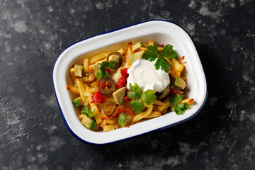 Loaded vegetarian fries with avocado, roasted peppers, jalapeno peppers and cheddar cheese