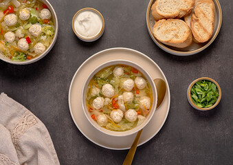 Food photography of soup with chicken meatballs and  vegetables, carrots, cabbage, broccoli,...