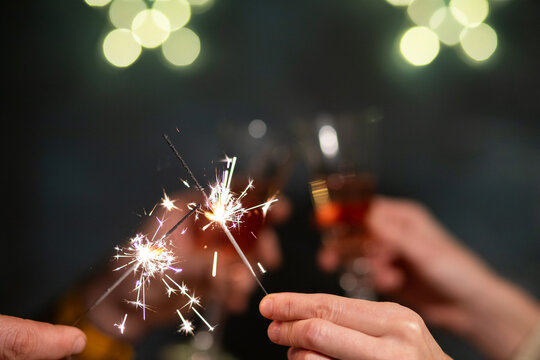 sparklers and toasting with champagne glasses