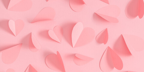 Holiday background of paper hearts for Valentine's Day. Pink hearts pattern on pastel pink background, Valentines day concept. Valentine. Flat lay, top view, copy space, banner