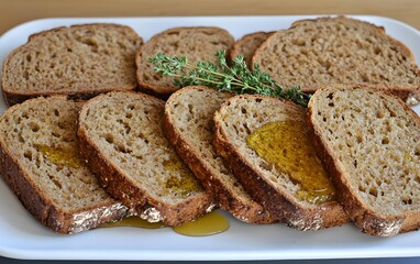Slices of brown bread drizzled with olive oil and garnished with thyme.