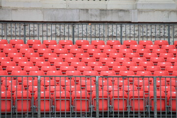 Empty red seats in stadium row in lines