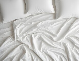 Crumpled white bedsheets and pillows, creating a soft, textured background