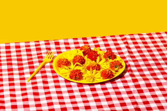 Bright floral picnic setup with a yellow and red palette