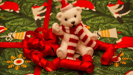 A Festive Christmas Bear adorned with Red Ribbons set on a delightful Holiday Background