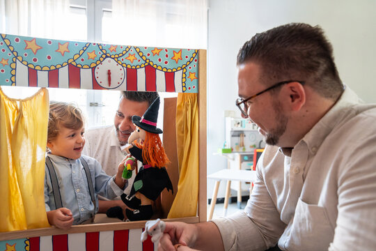 Loving gay parents with their son enjoying playtime at home