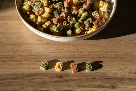 number shaped pasta spelling out the year 2025 on wooden surface