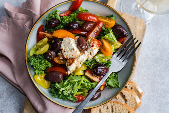 Top view of colorful healthy Kale salad with spiced feta