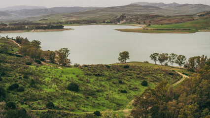 An exquisite and serene landscape featuring a picturesque lake surrounded by lush greenery