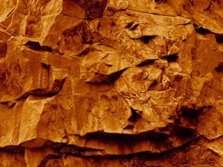 Orange brown red fire gold yellow stone surface. Mountain rock sandstone. Close-up. Bright. Design. Nature.
