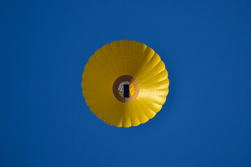 yellow hot air balloon against blue sky