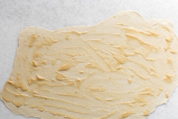 Overhead view of oil and flour mixture on raw chinese scallion pancakes dough, top view of homemade scallion pancakes, process of making cong you bing