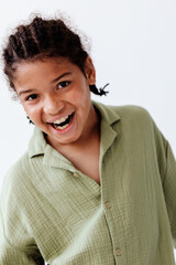 Happy young boy in green shirt with a trendy smile standing confidently in portrait