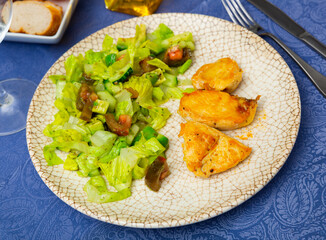 Fresh salad with chicken breast and lettuce on a plate