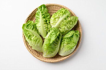 Baby cos lettuce romaine in basket on white background, Fresh vegetable, Top view