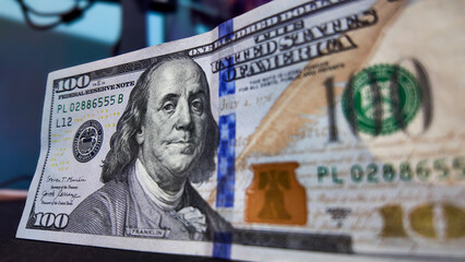 100 dollars, several bills in hand