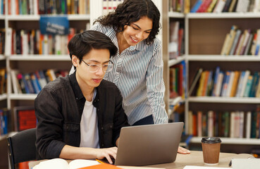 Academic Advisor. Female brazilian counselor monitoring work of korean architect student who using...