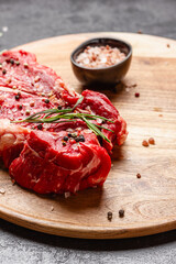 Raw beef meat on a wooden tray