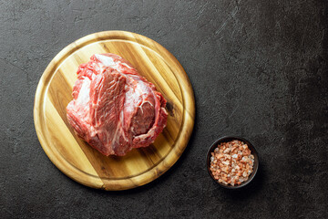 Raw beef meat on a wooden cutting board