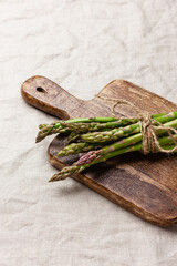 Green asparagus on a wooden cutting board