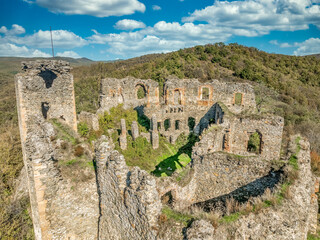 Fototapeta premium Aerial view of Soimos medieval castle in Romania near Lipova above the Mures river with Gothic details