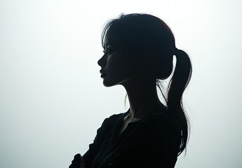 A silhouette of  woman's face against a white background