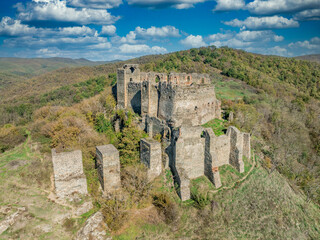 Fototapeta premium Aerial view of medieval Solymos, Soimos castle ruin in Romania above the Mures river, square keep, gate house, concentric walls near Lipova