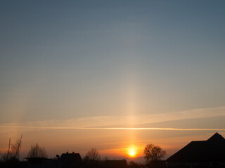 Natural light phenomenon. Halo and light pillar.
