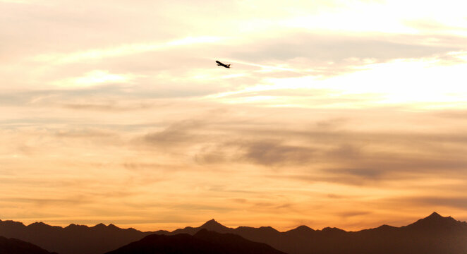 Airplane in the desert sky at golden hour