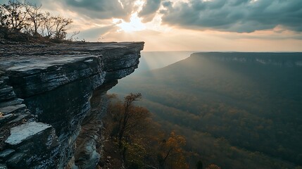 Majestic cliff overlooking autumnal valley sunset