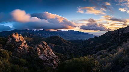 Dramatic Sunset Over Mountain Range and Rugged Rocks