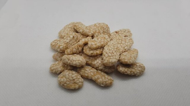 A Kue Keciput, Indonesian traditional snack made from glutinous rice flour, eggs, sugar and sprinkled with sesame seed hd 4k
