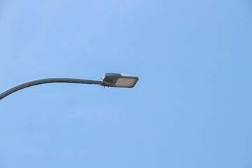 Automatic street lamp pole with solar panel system over the clear blue sky background