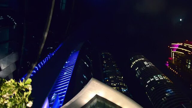 Abu Dhabi, skyward view of modern business skyscrapers at night