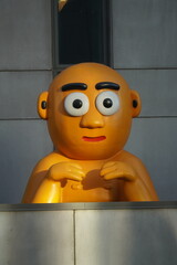 orange bald man statue 