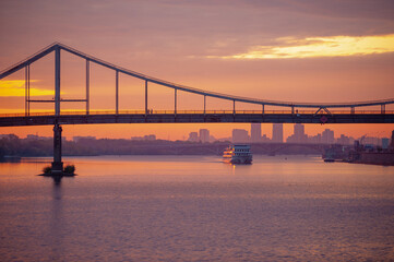 sunrise in Kyiv with view of Dnieper and pedestrian bridge for banner background