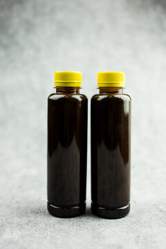 Two ottle of chocolate milk or cocoa milk in transparent bottle with yellow lid. Healthy chocolate and quite popular take a home