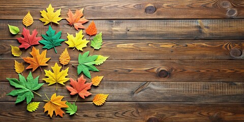 Fototapeta premium A cluster of colorful paper leaves scattered on a wooden background