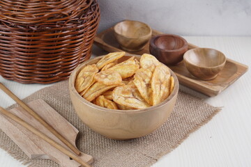 Indonesian banana chips on a wooden bowl with a traditional property theme photographed with studio light